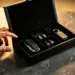 Luxuriöse schwarze Leder-Geschenkbox mit Chrom-Autozubehör auf Marmorfläche, goldene Beleuchtung betont samtiges Interieur