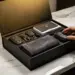 Luxuriöse schwarze Ledergeschenkbox mit Magnetverschluss auf Marmoroberfläche, gefüllt mit Premium-Autozubehör wie Lederschlüsselanhängern und Mikrofasertüchern