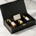 Schwarze Matte-Geschenkbox mit Samteinlage, Luxus-Hautpflegeprodukten und handgeschriebenem Kärtchen auf weißem Marmor.