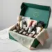 Geöffnete Premium-PR-Box in Smaragdgrün mit Goldakzenten zeigt Lifestyle-Produkte in schwarzen Schaumstoffeinsätzen